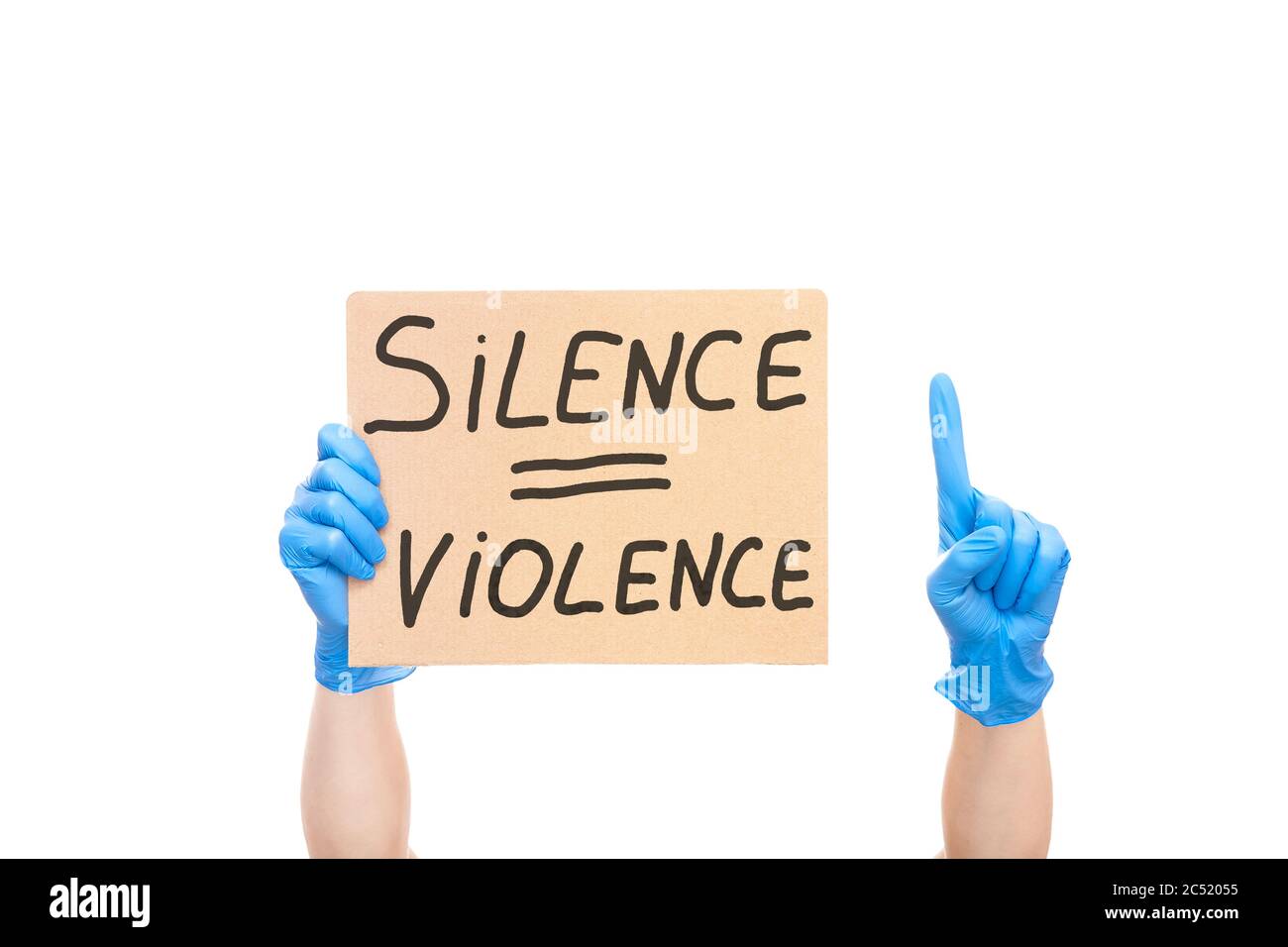 protest shows index finger up and  hand on glove holding a cardboard poster with the message text silence is violence isolated on white background, co Stock Photo
