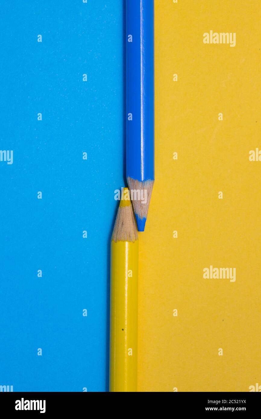 Colored pencil crayons on a colored card surface Stock Photo
