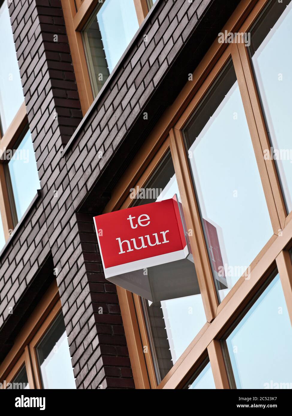 Dutch for rent sign on an apartment building in Amsterdam Stock Photo