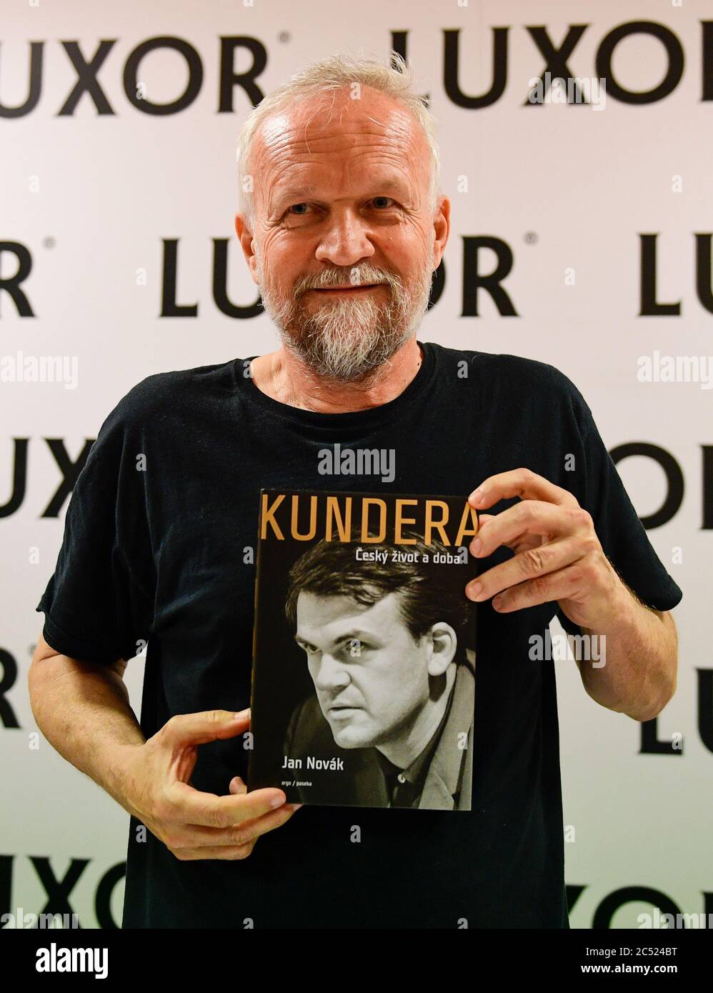 Prague, Czech Republic. 29th June, 2020. Czech author Jan Novak poses with his new literary biography of Czech-born writer living in France Milan Kundera, 91, called Kundera: The Czech Life and Times, on June 29, 2020, in Prague, Czech Republic. Novak worked on the biographical novel for four years. But he did not talk to Kundera since the writer, living in Paris for 45 years, did not react to Novak's requests for consultations. Credit: Katerina Sulova/CTK Photo/Alamy Live News Stock Photo