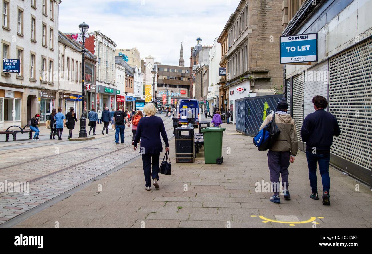 Dundee, Tayside, Scotland, UK. 30th June, 2020. UK Weather: Humid day with some bright and sunny spells across North East Scotland, maximum temperature 19°C. Second day of Non-essential shops re-opening as shoppers take the day out shopping in Dundee city centre. Among those re-opened are the High Street stores, Murraygate stores, the Wellgate and the Overgate shopping centres and staff are welcoming customers back with new Covid-19 guidelines of social distancing. Credit: Dundee Photographics/Alamy Live News Stock Photo