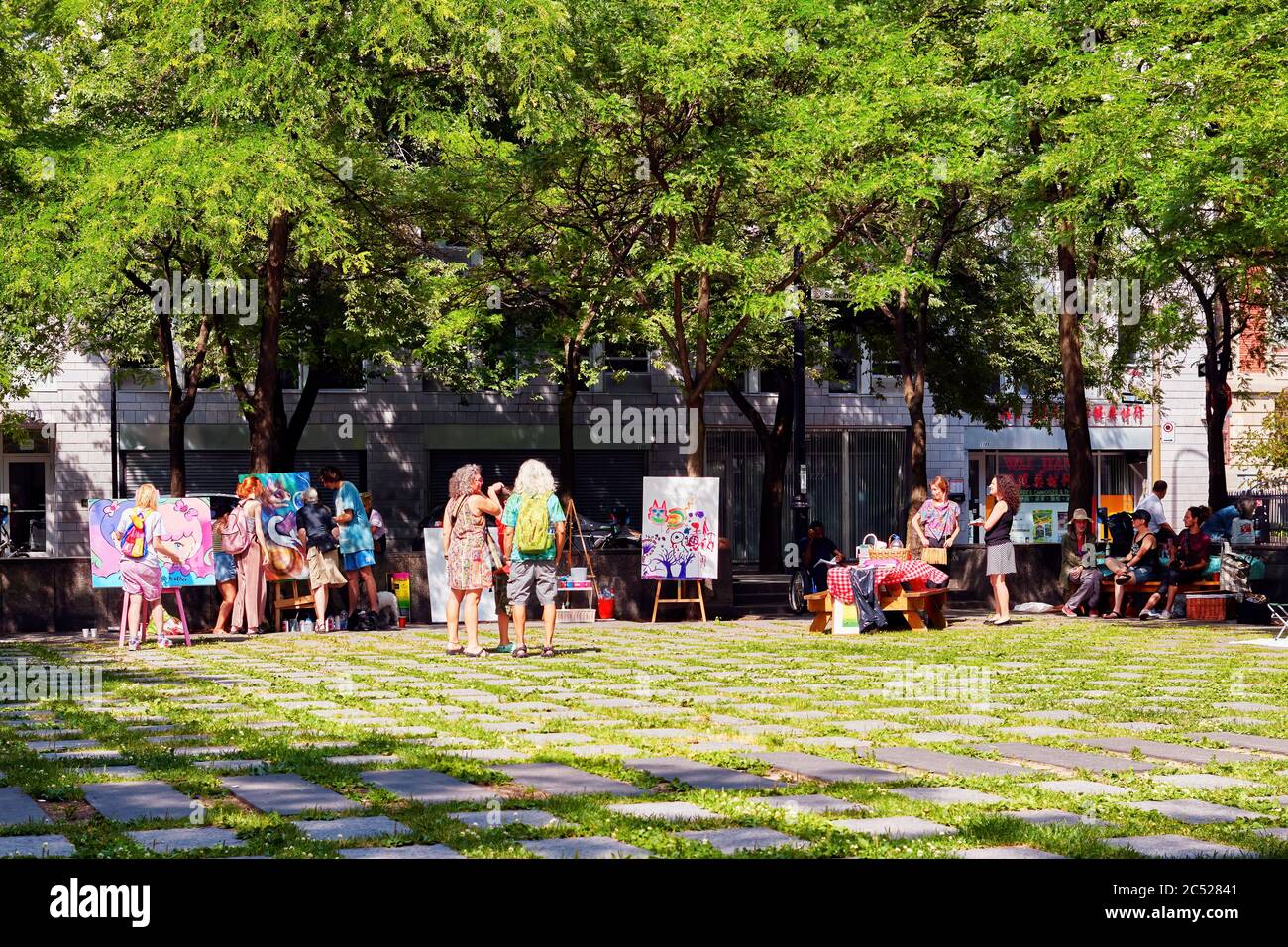 Montreal, Canada - June, 2018: Diversity of Canadian people in peace park or place de la paix in Montreal, Quebec, Canada. Cultural public life in Can Stock Photo