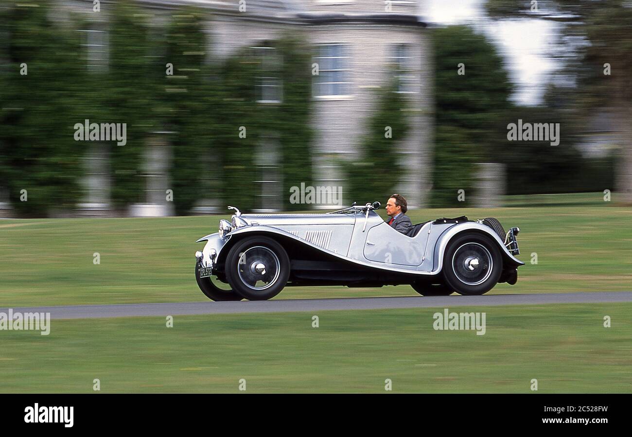 Charles Gordon- Lennox 11th Duke of Richmond driving his 1934 AC 16-80 Six sports car at Goodwood House UK  2002 Stock Photo