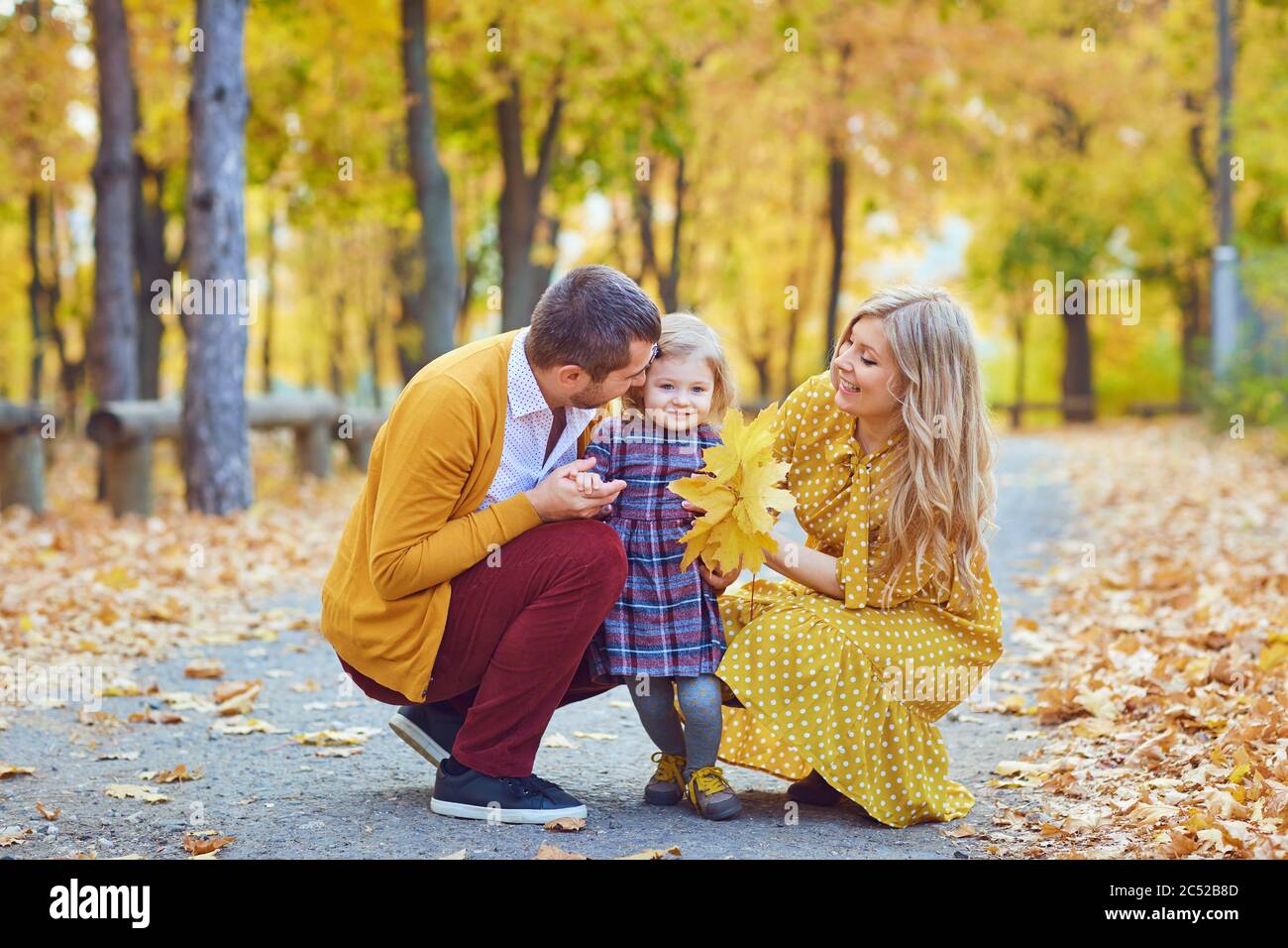 Family with daughter in the park in the fall. Stock Photo