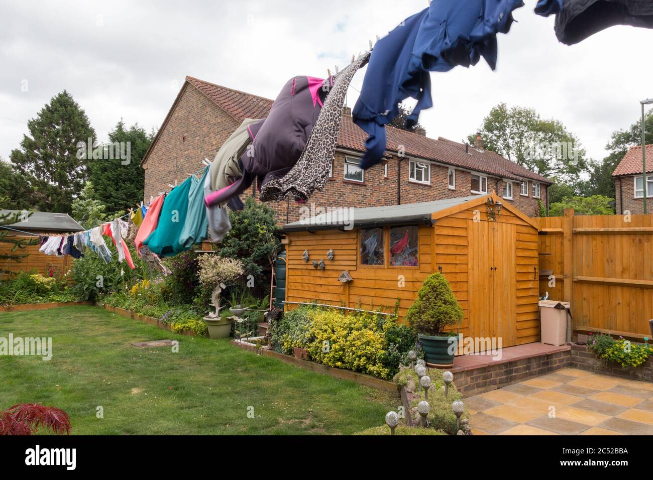 Washing hanging on long line drying in the gusty windy weather. Full