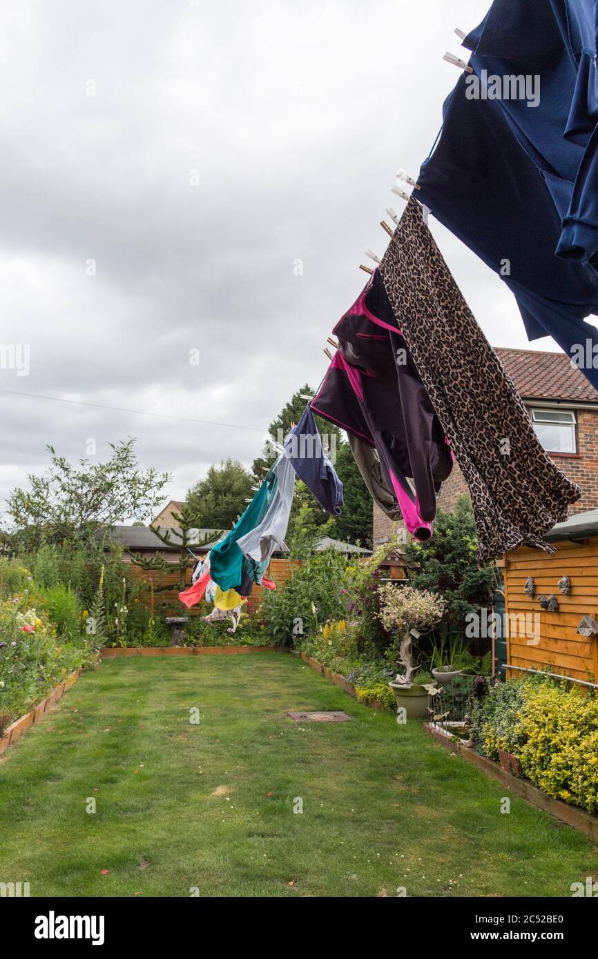 Washing hanging on long line drying in the gusty windy weather. Full
