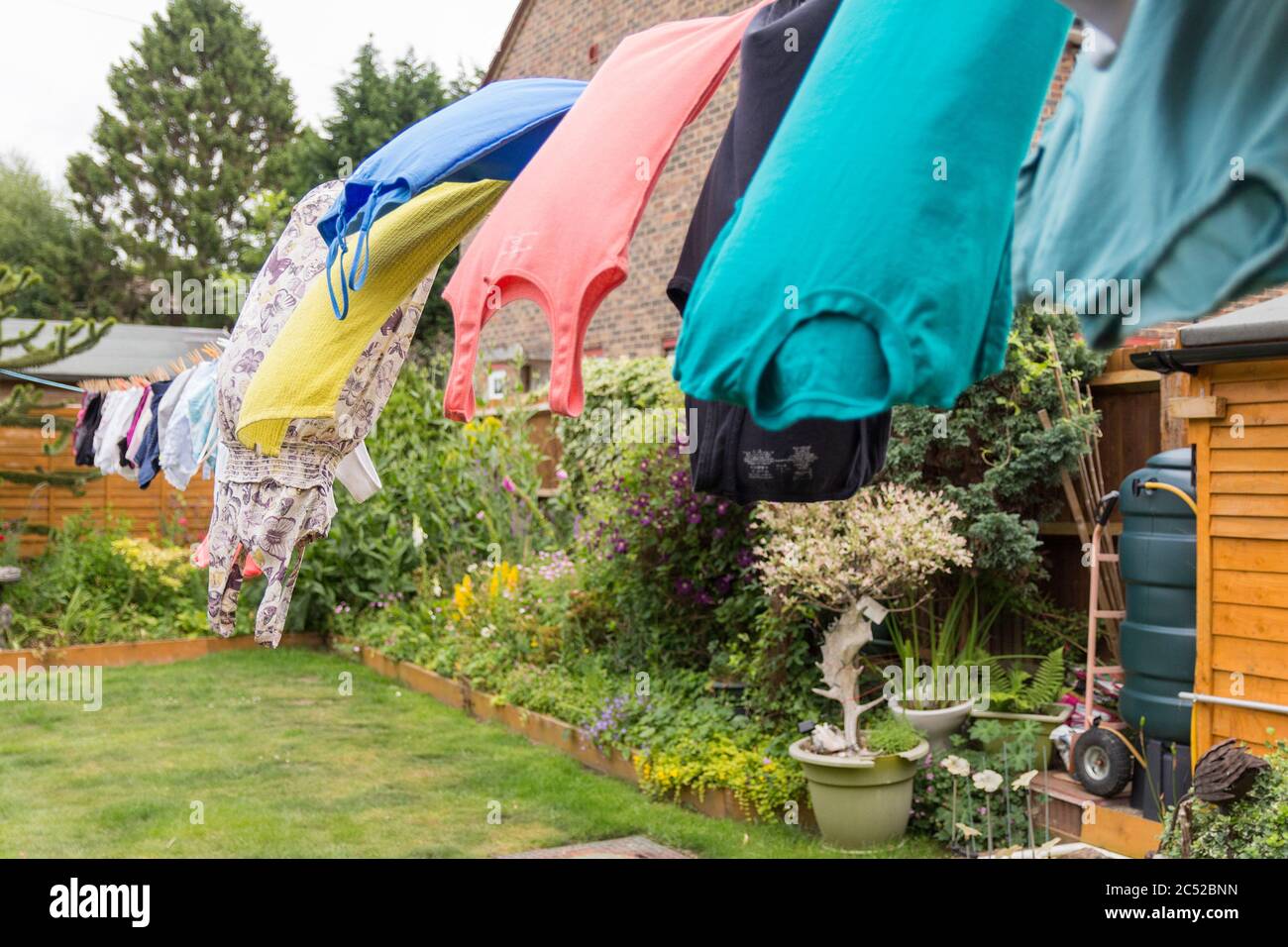 Washing hanging on long line drying in the gusty windy weather. Full