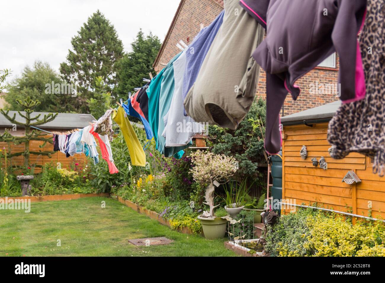 Washing hanging on long line drying in the gusty windy weather. Full