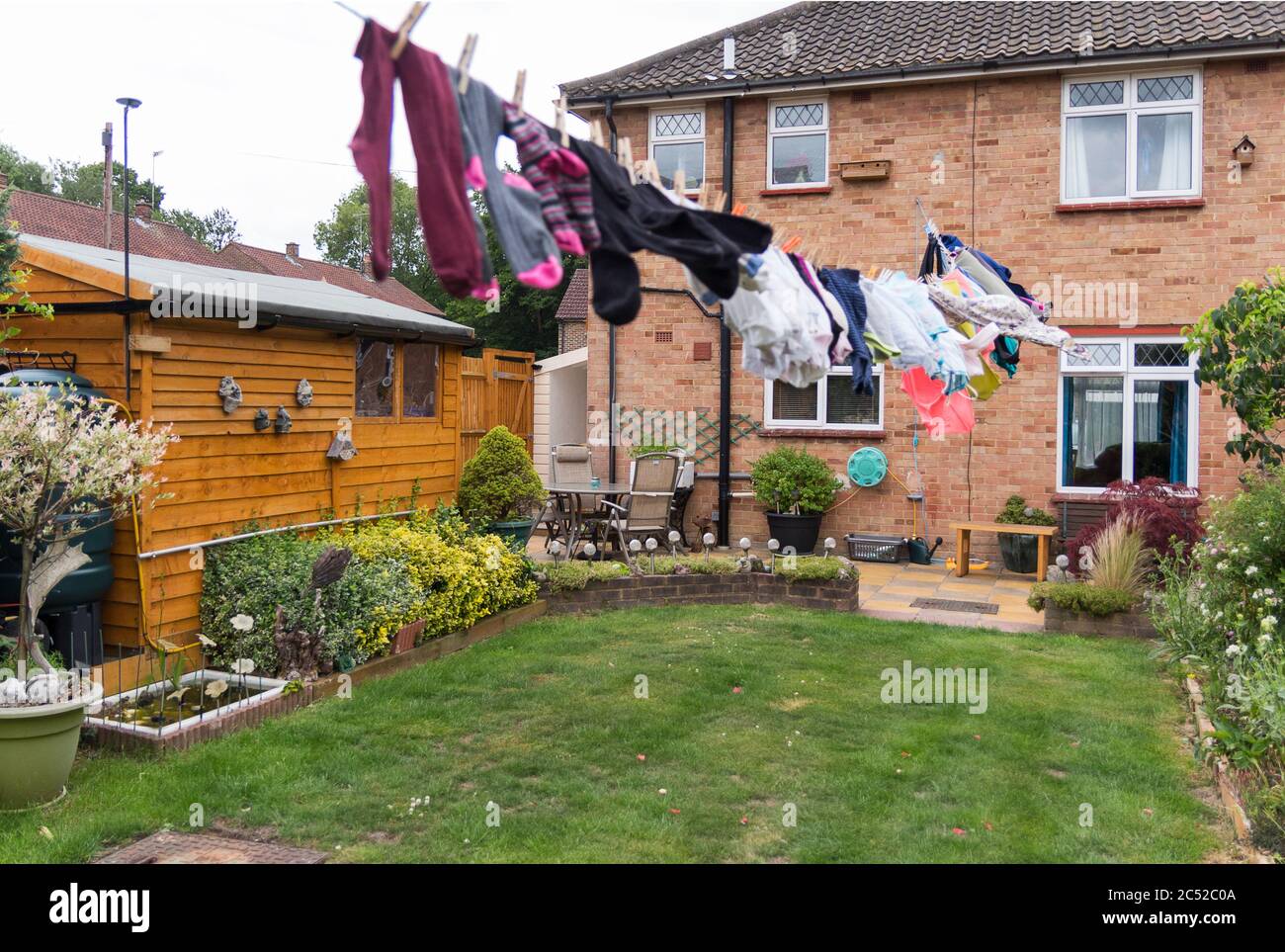 Washing hanging on long line drying in the gusty windy weather. Full