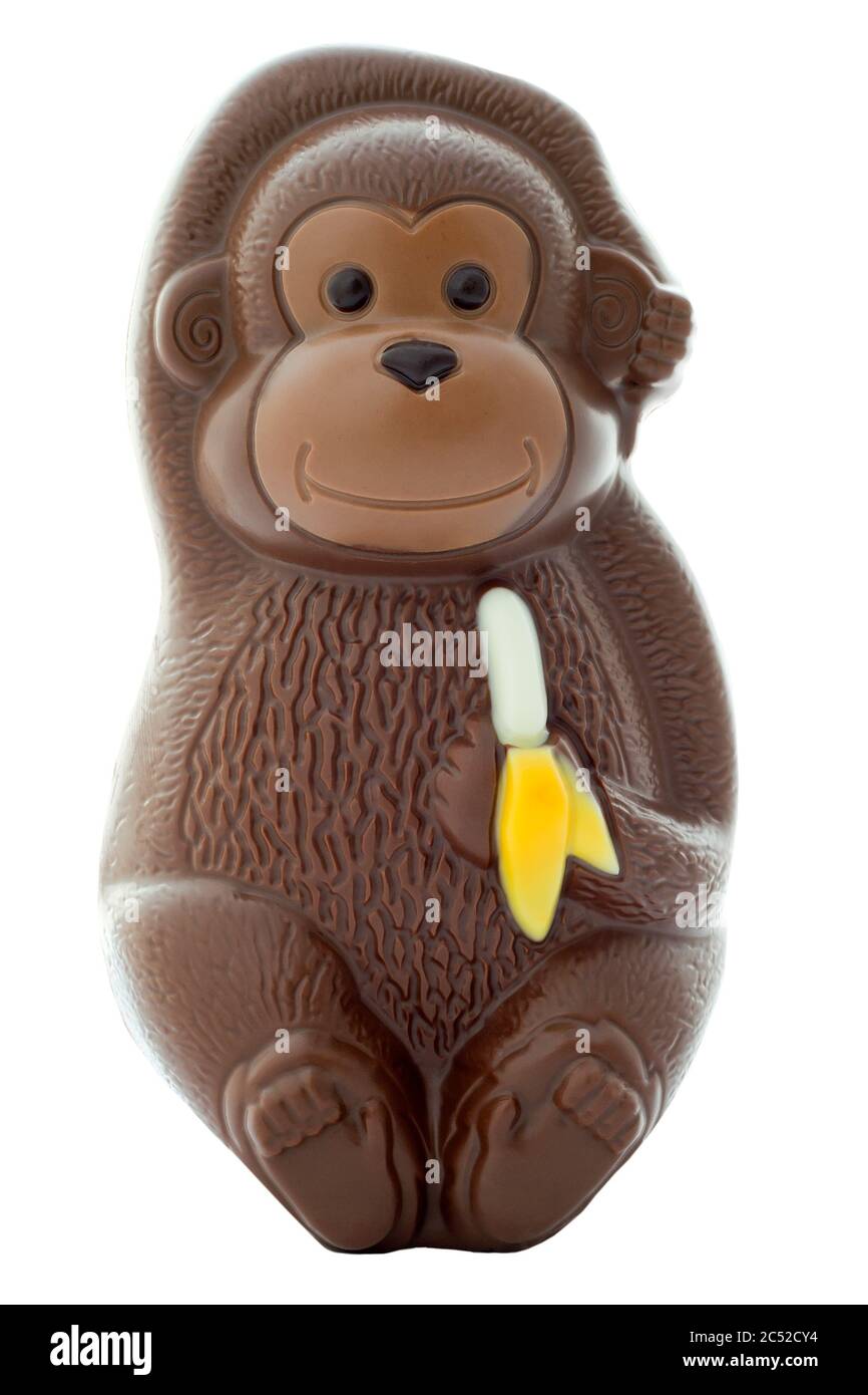 Chocolate monkey figurine holding a banana on an isolated white background with a clipping path Stock Photo