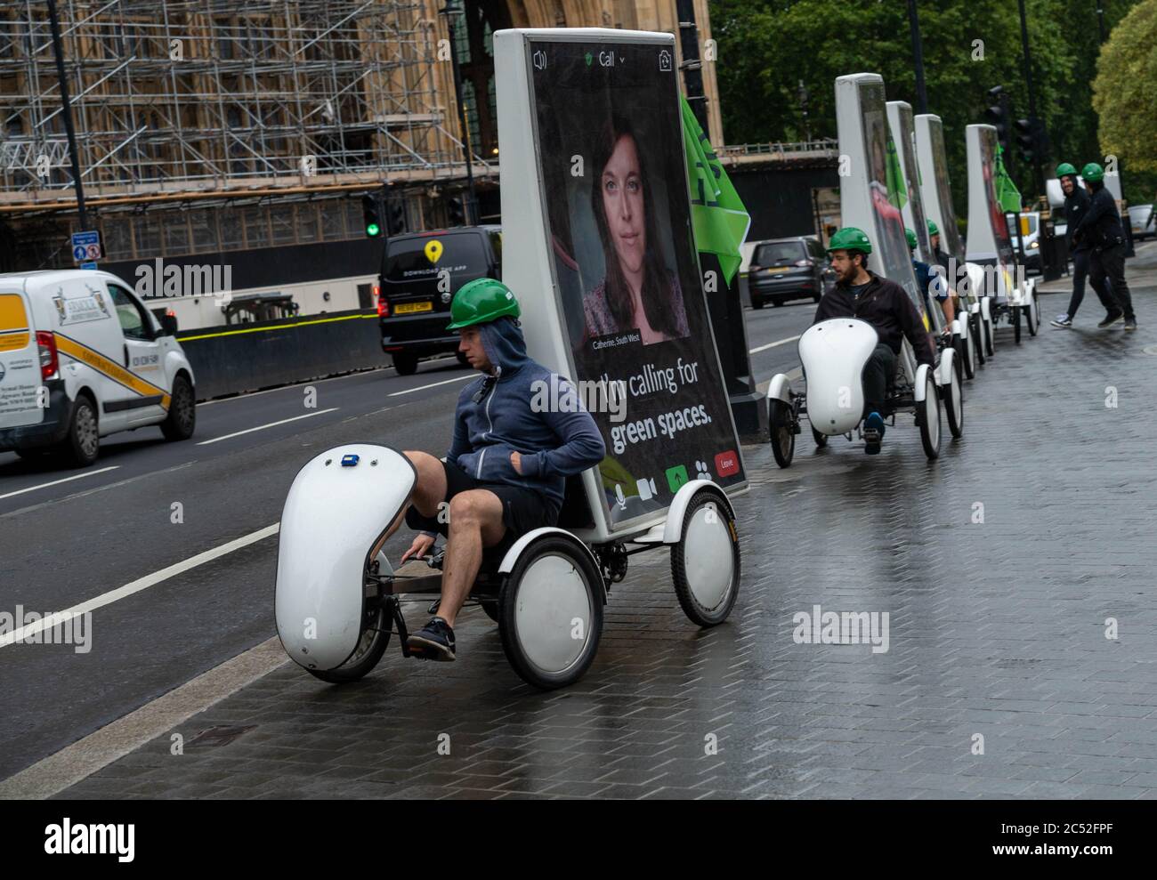 London, UK. 30th June, 2020. Green party activists ride advertsing bikes around Westminster ahead of a lobby of Parliament by Green party members and supporters Credit: Ian Davidson/Alamy Live News Stock Photo