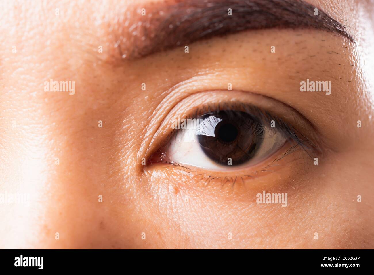 Close up detail macro of iris eyebrow or eyes Asian young woman open eyeball, studio shot background, Healthcare beauty concept Stock Photo
