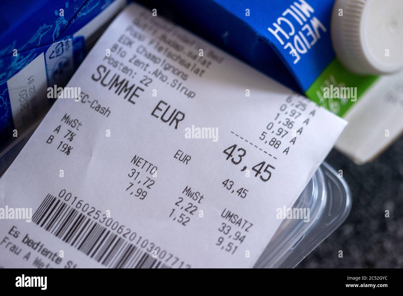 Schwerin, Germany. 30th June, 2020. A purchase receipt with the details of the value added tax at 7 or 19 percent is on a shopping bag with food. From 01.07.2020 until the end of the year, only 16 instead of 19 percent VAT will be charged on shopping, the reduced rate will drop from 7 to 5 percent. With this, the Federal Government wants to boost consumption again after the Corona crisis. Credit: Jens Büttner/dpa-Zentralbild/dpa/Alamy Live News Stock Photo