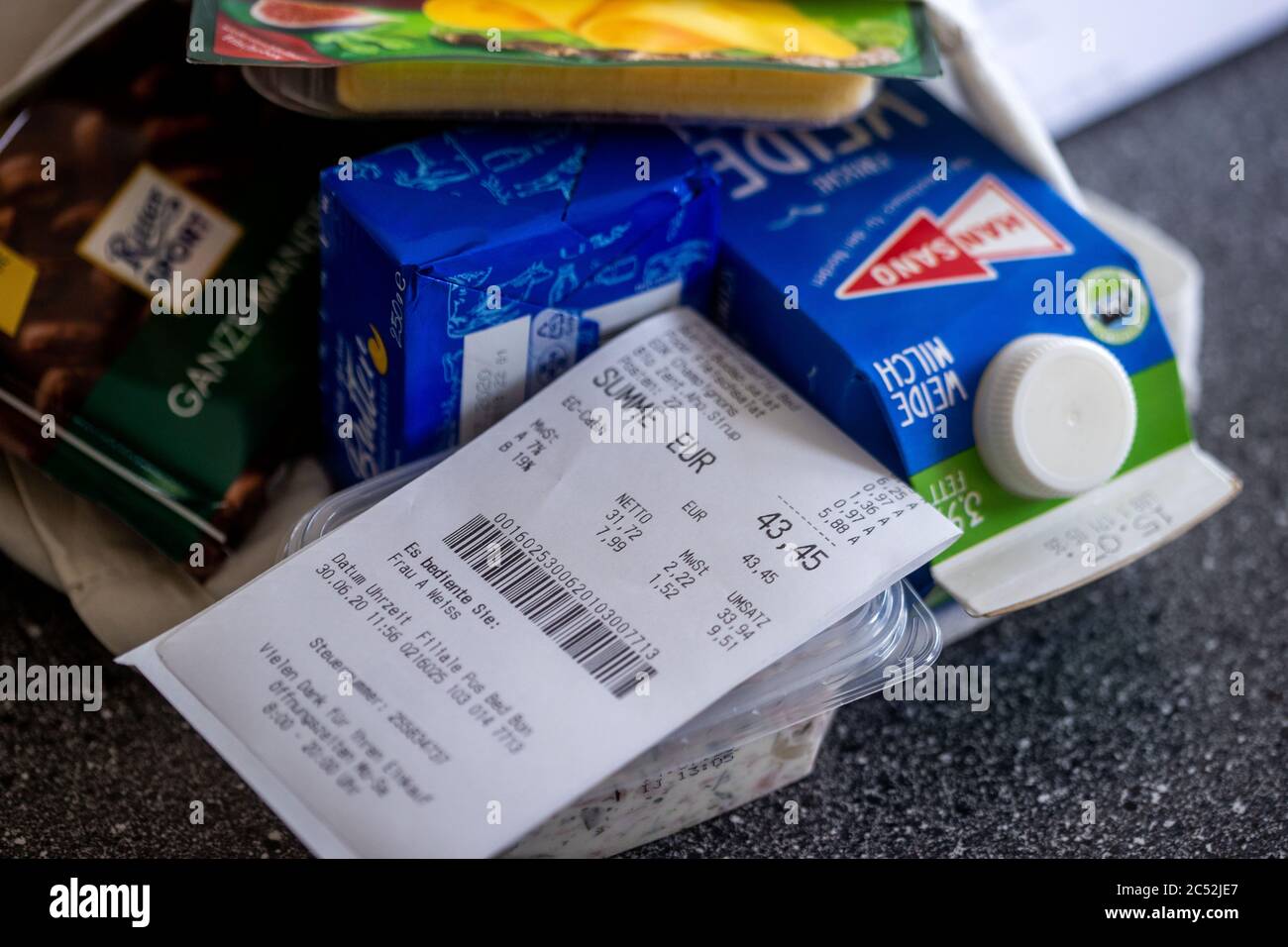 Schwerin, Germany. 30th June, 2020. A purchase receipt with the details of the value added tax at 7 or 19 percent is on a shopping bag with food. From 01.07.2020 until the end of the year, only 16 instead of 19 percent VAT will be charged on shopping, the reduced rate will drop from 7 to 5 percent. With this, the Federal Government wants to boost consumption again after the Corona crisis. Credit: Jens Büttner/dpa-Zentralbild/dpa/Alamy Live News Stock Photo