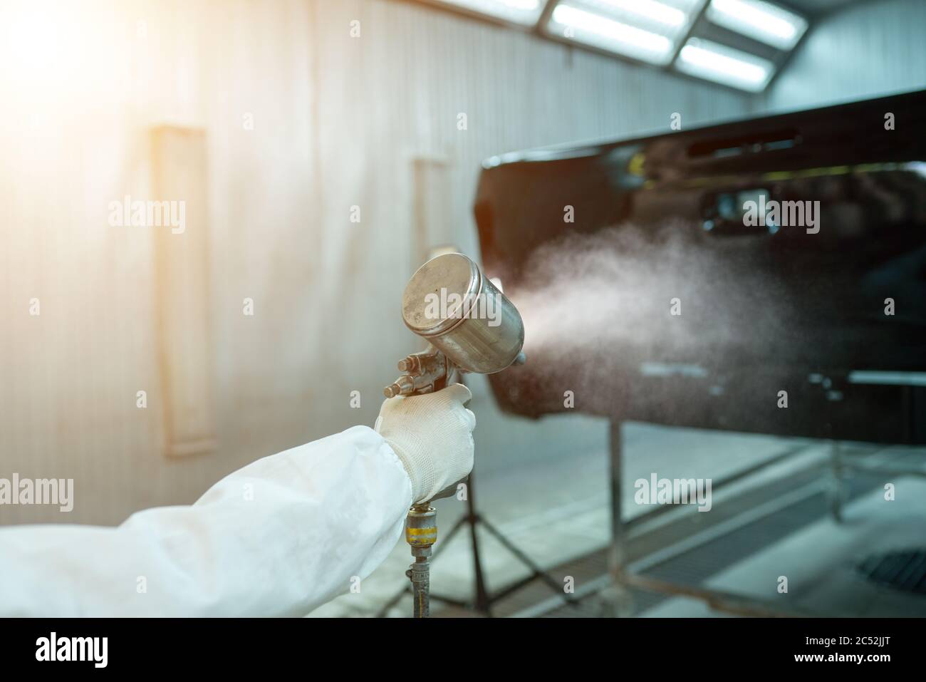 Mechanic spray painting a car in a garage, Thailand Stock Photo Alamy
