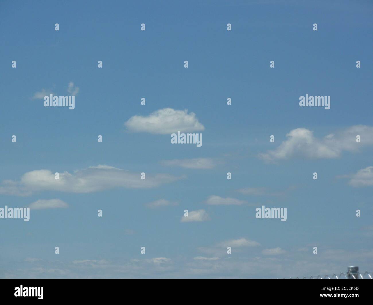 Low angle shot of white clouds in a blue sky at daytime Stock Photo - Alamy