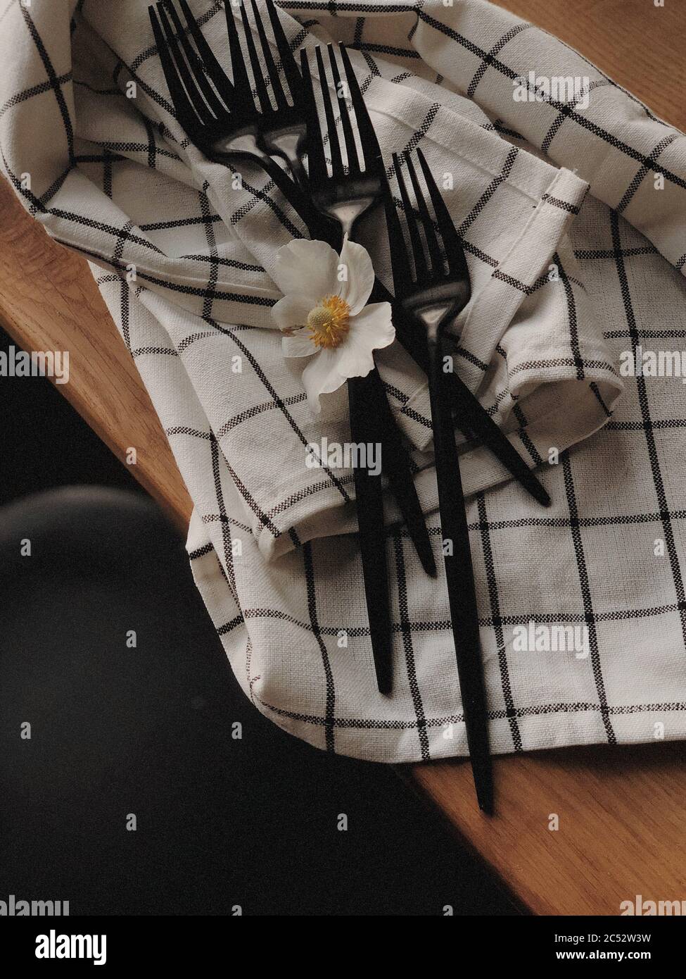 Plastic forks on a tea towel on the table Stock Photo