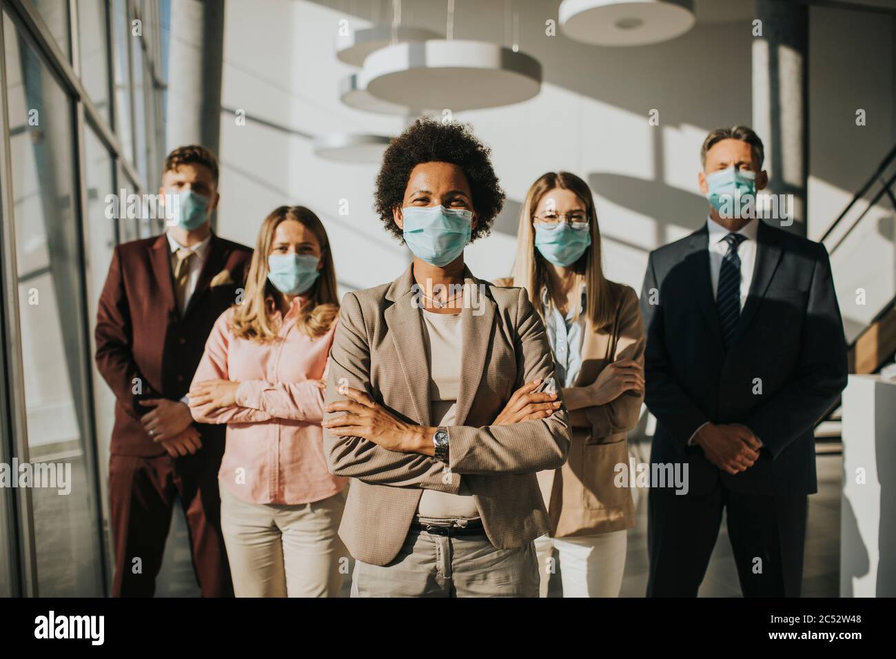 Group of asian business people standing in the office and wear mask for protect prevent infection by corona virus Stock Photo