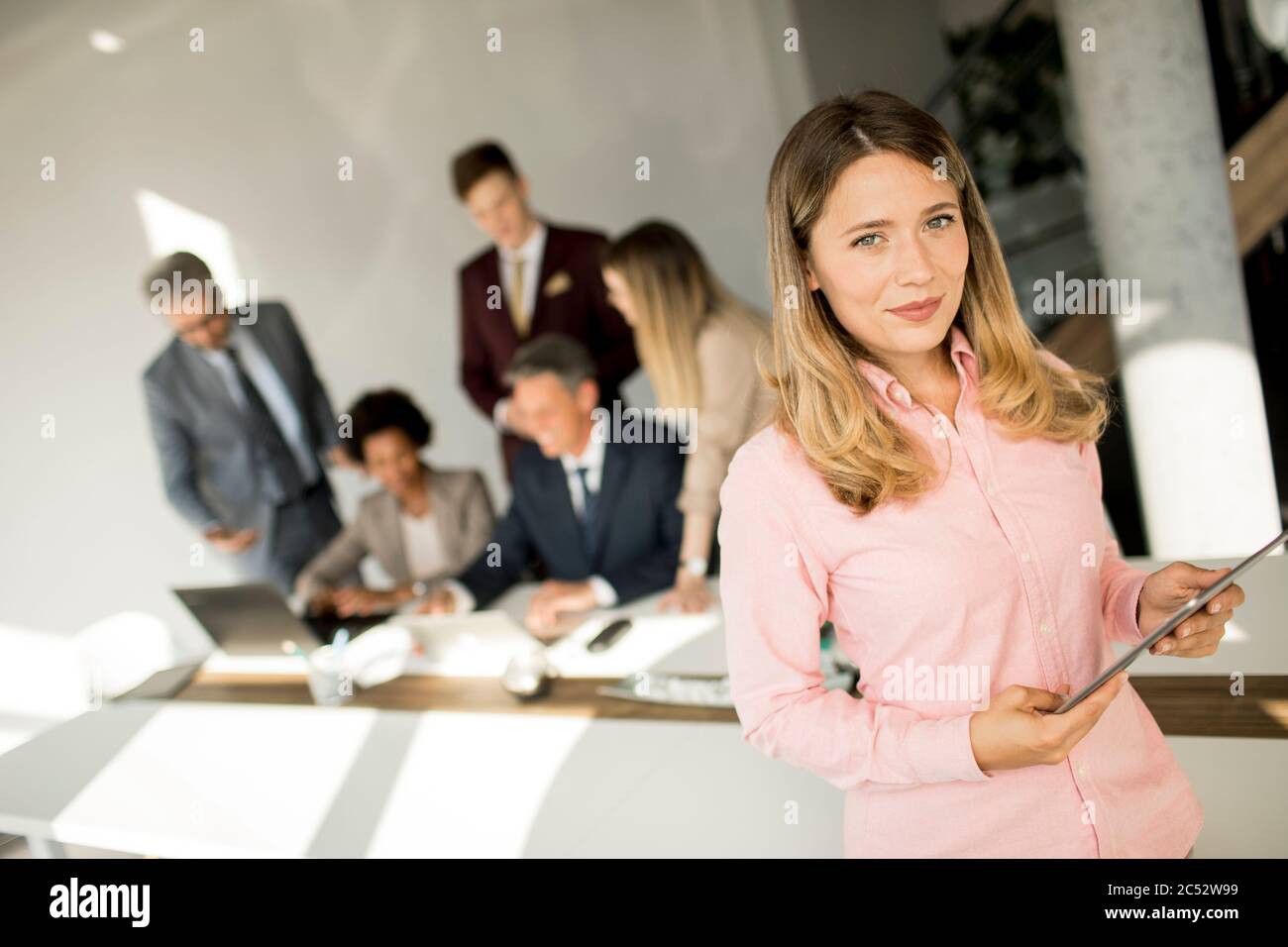 Pretty young business woman using digital tablet in the office Stock Photo