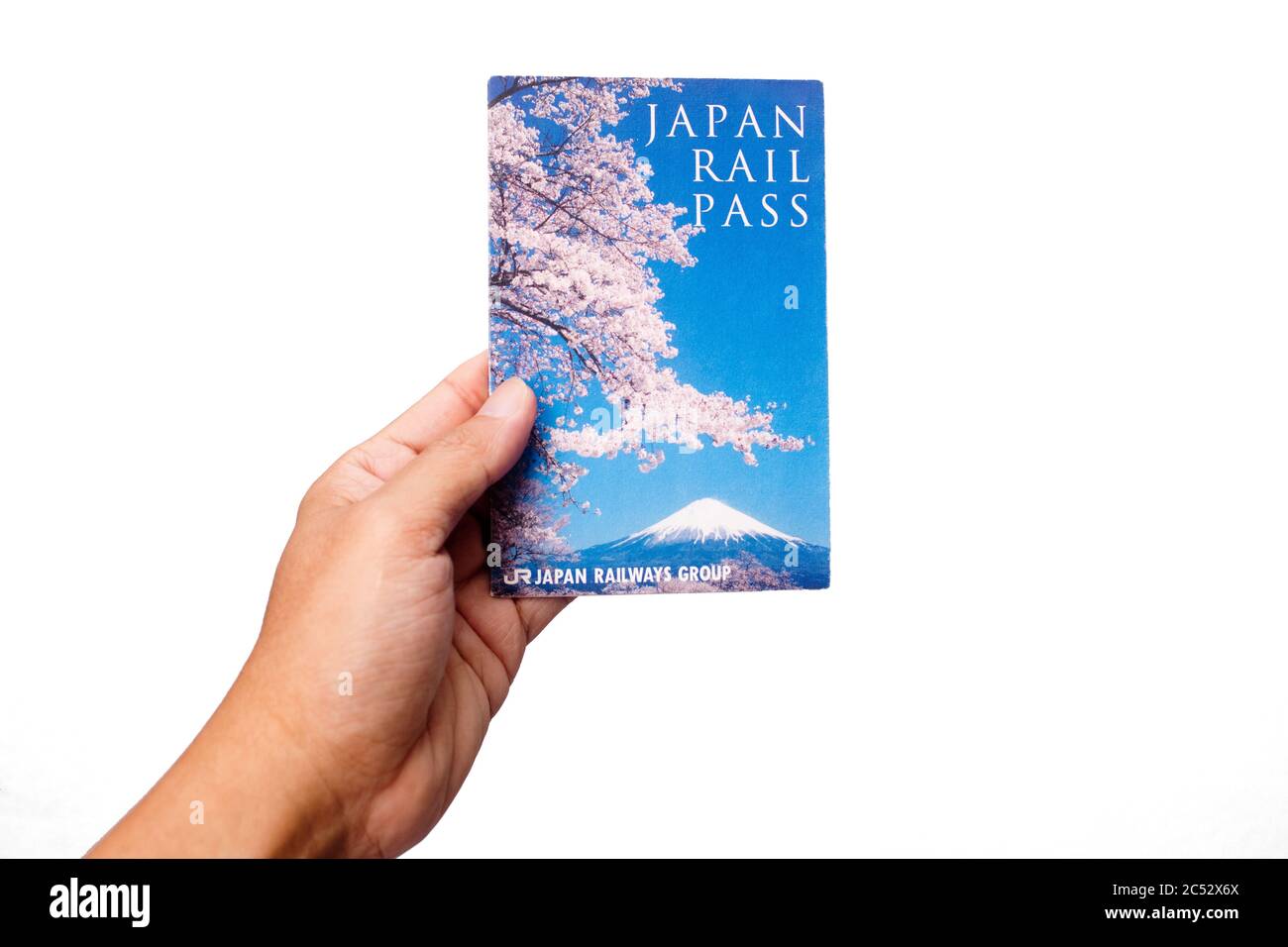 Penang, Malaysia - May 25, 2020 : Close up view of a hand holding a used Japan Rail Pass on red background at Gelugor Stock Photo