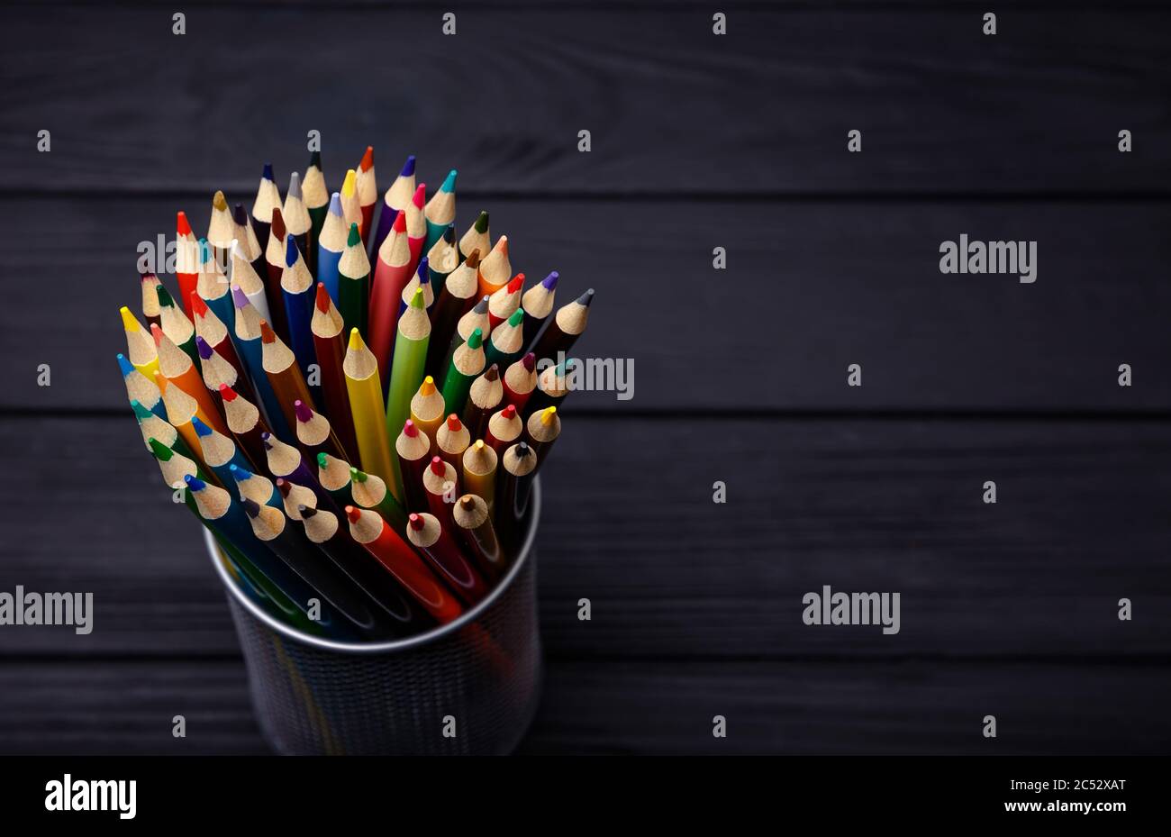 Various Colored Pencils isolated on black background. Macro Stock Photo