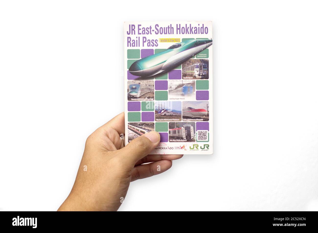 Penang, Malaysia - May 25, 2020 : Close up view of a hand holding a used JR East South Hokkaido Rail Pass on white background at Gelugor Stock Photo