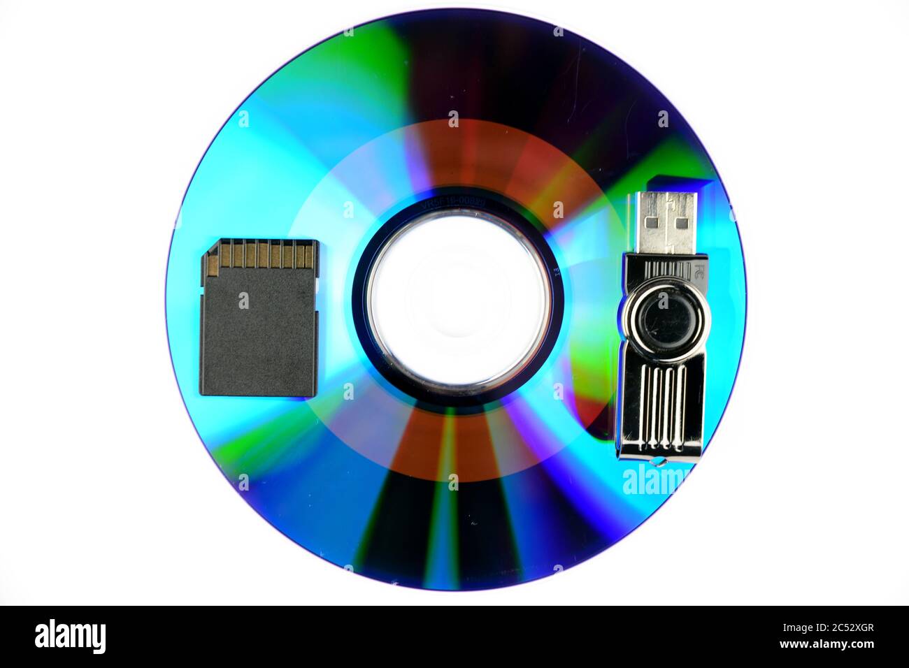 High angle shot of a disc with a memory card and USB flash drive  on a white surface Stock Photo