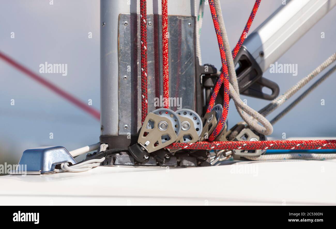 Pulley and rope system at the base of the mast for  sail installing on board the yacht Stock Photo