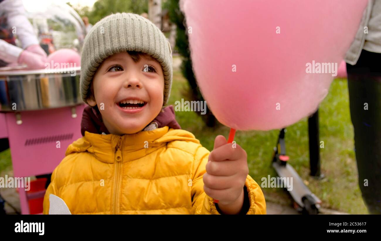 Boy eating candy floss in park Stock Photo