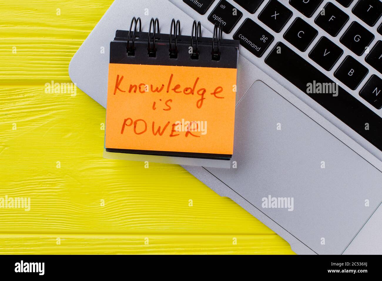 Top view laptop and knowledge is power slogan Stock Photo Alamy