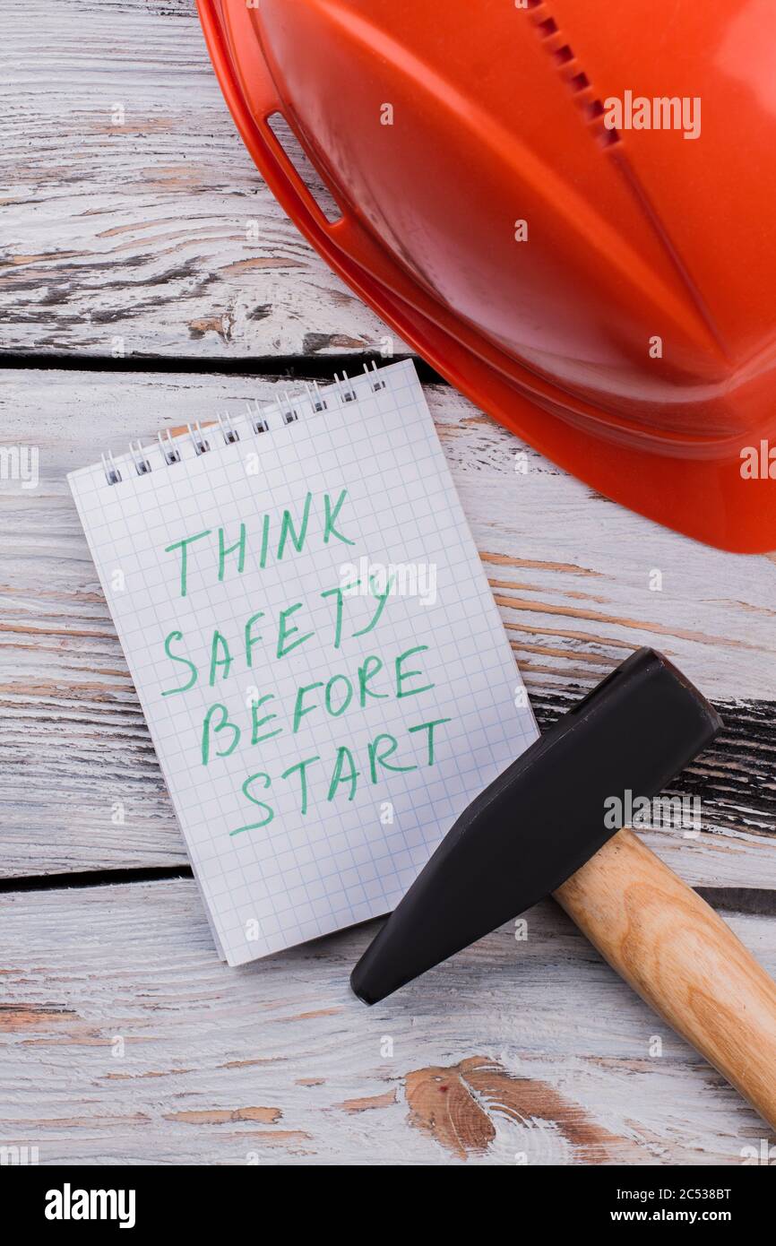 Think safety before start note and working tools on wooden table Stock