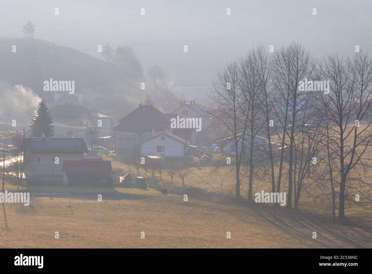 Village in a morning mist in Turiec region, Slovakia. Stock Photo