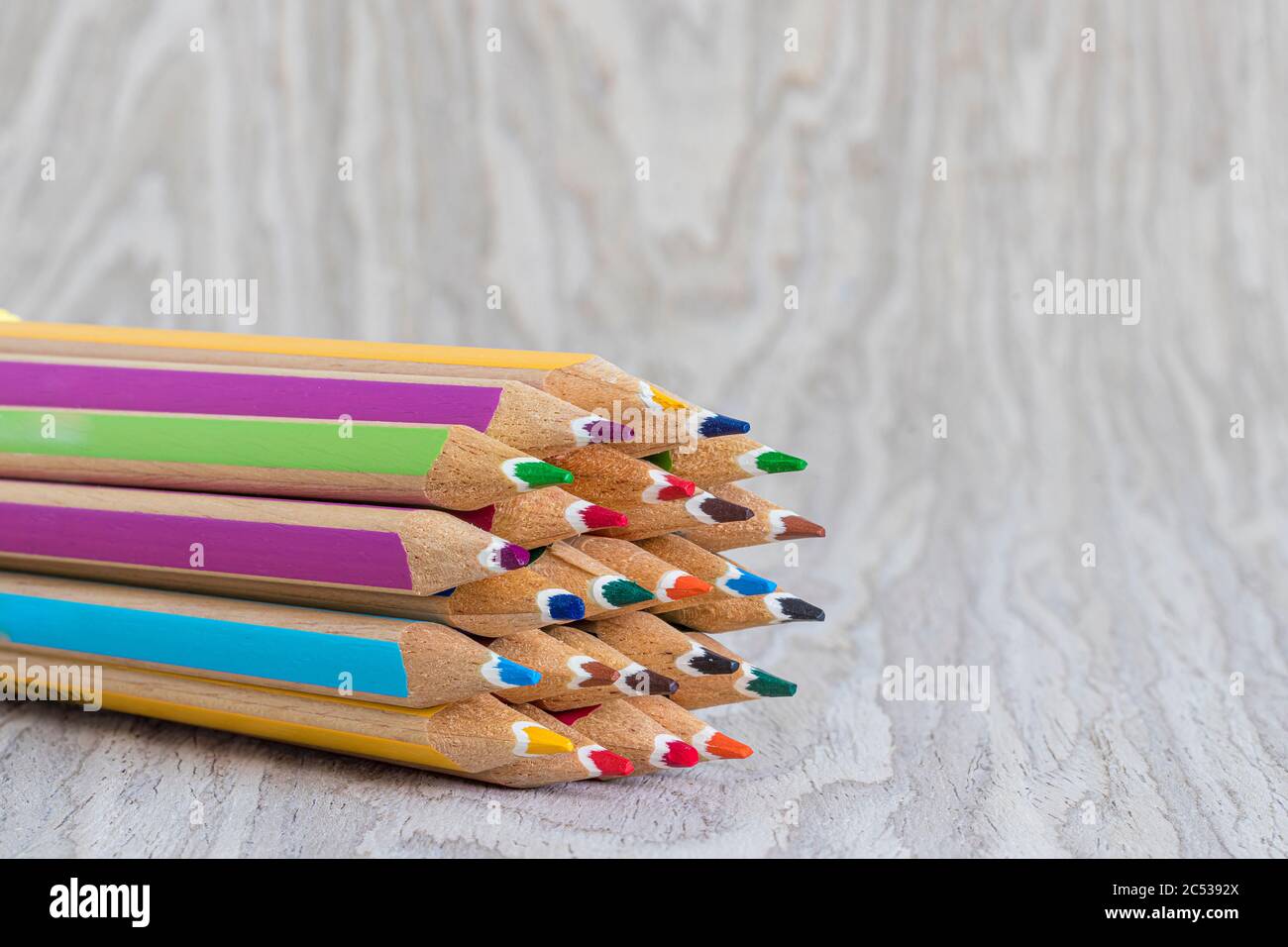 Colorful wooden crayons on a wood texture Stock Photo Alamy
