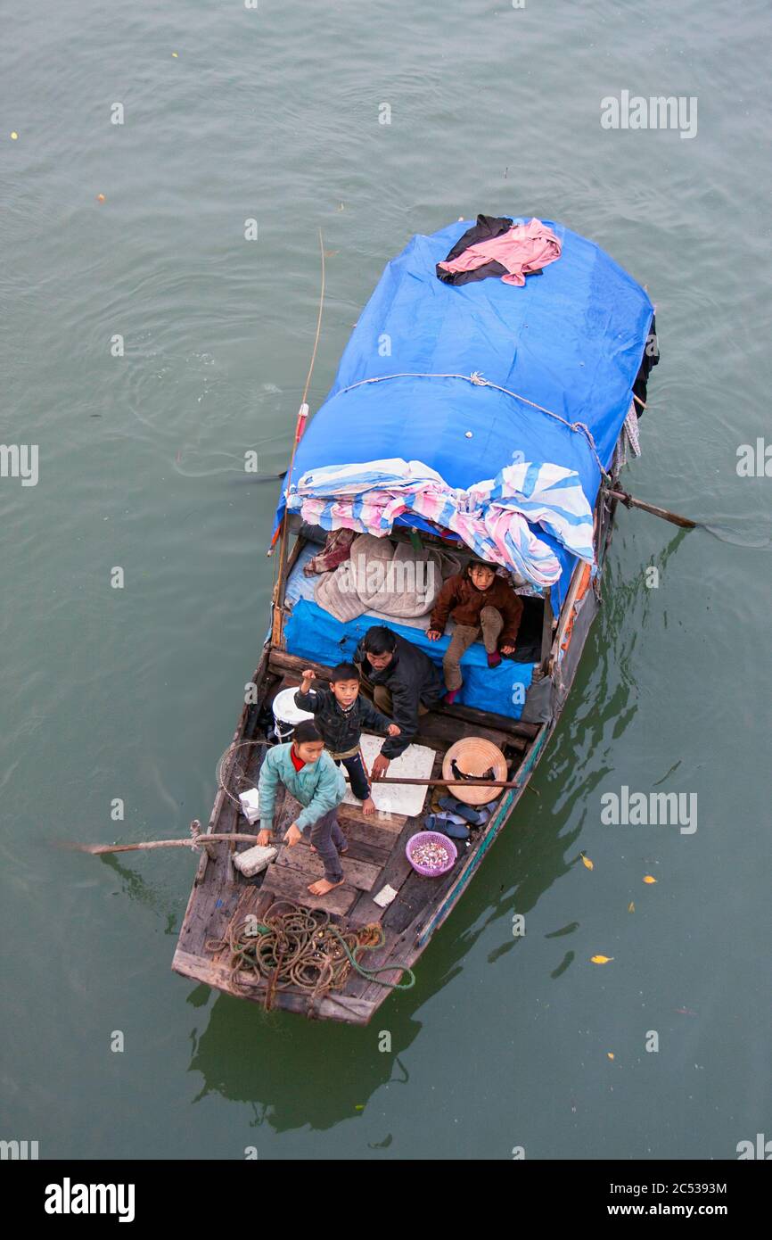 poor Vietnamese family members living in a house boat, poverty vietnam,halong bay,vietnames family,poor people,asia poor people,halong bay vietnam Stock Photo