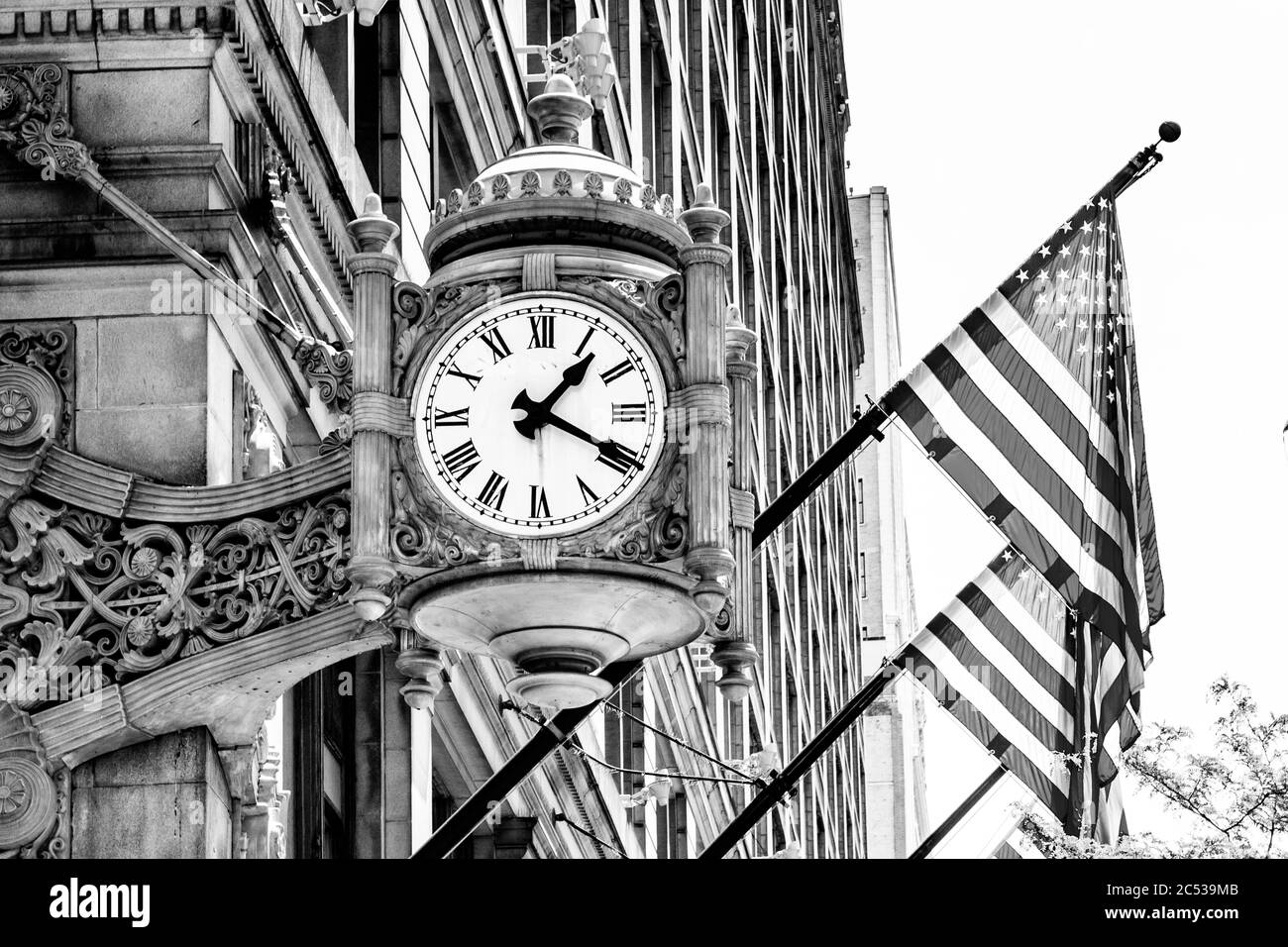 Black and White iconic landmark Marshall Field and Company clock in downtown Chicago by Graham, Anderson, Probst and White. Stock Photo