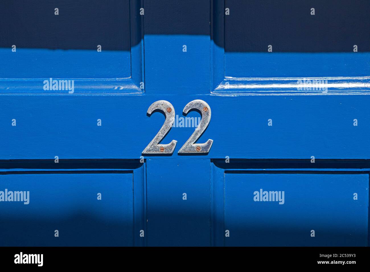 Blue door with the number 22 on it. Stock Photo