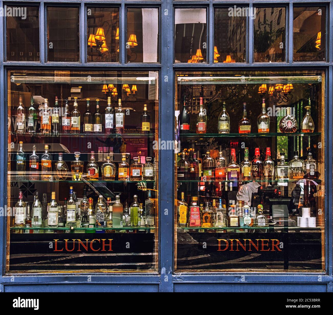 New York City, USA, May 2019, close up of a bar window with some bottles on the shelves view from the street in Hell's Kitchen Stock Photo