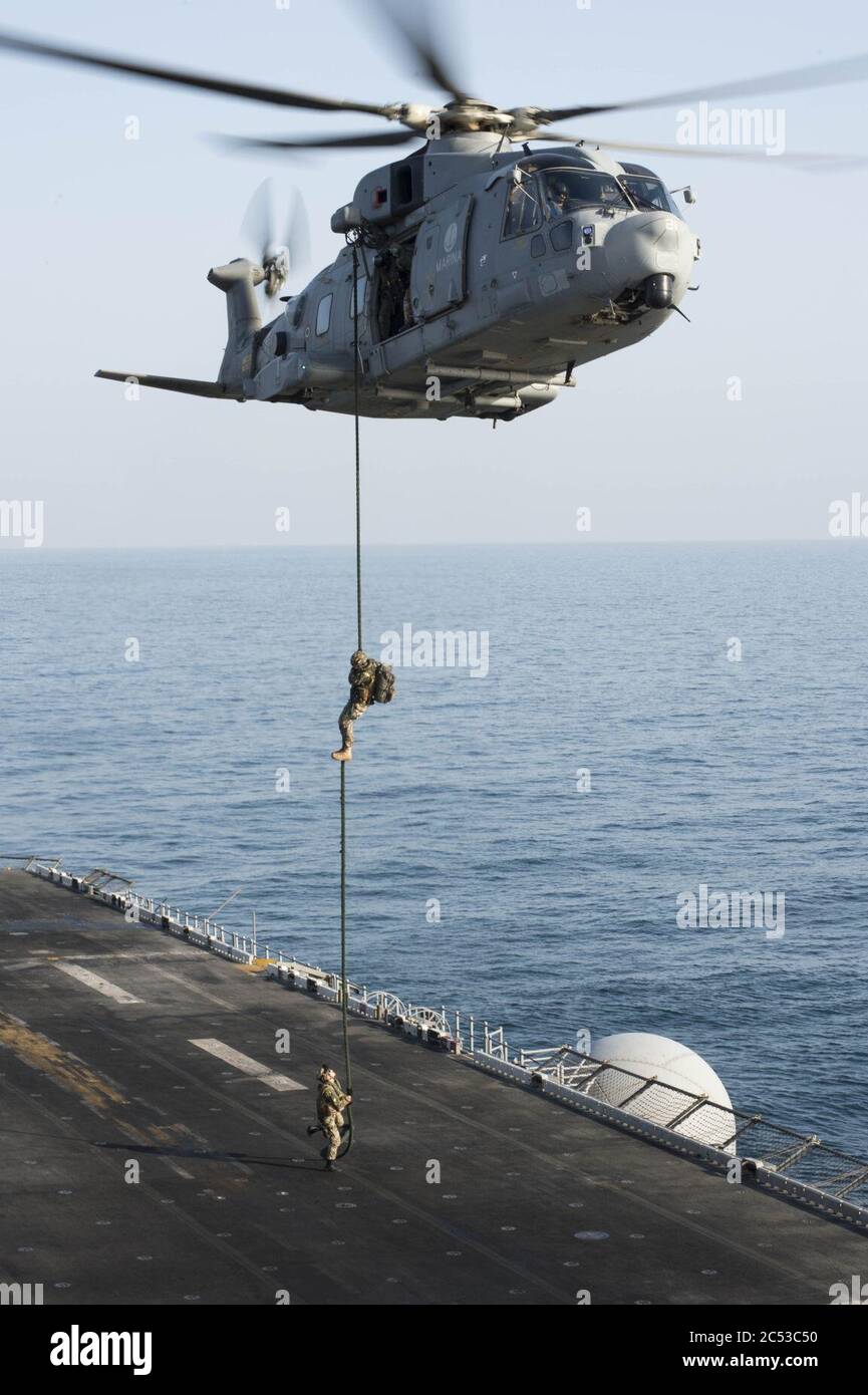 Italian marines fast rope from EH101 onto USS Boxer (LHD-4) in