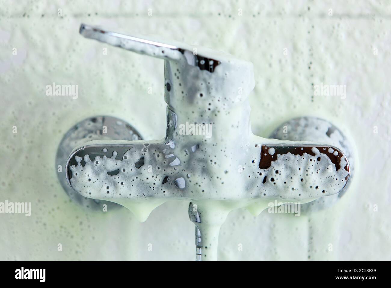 Foam, descaler on the bathroom tap Stock Photo Alamy