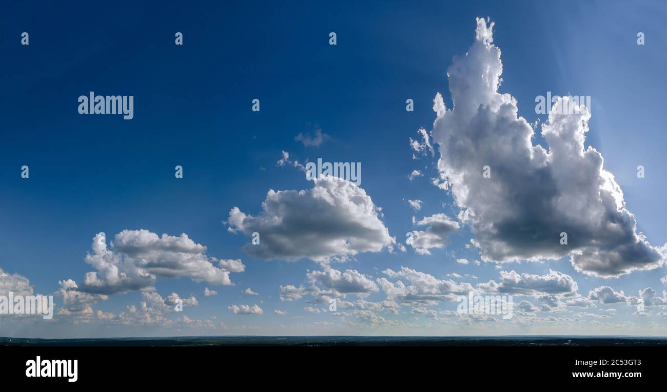 Sunny day cumulus scape white fluffy clouds in the blue sky with ...