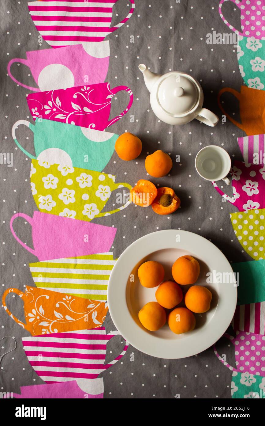 Bright colorful towel with drawings of cups and apricots on it Stock Photo