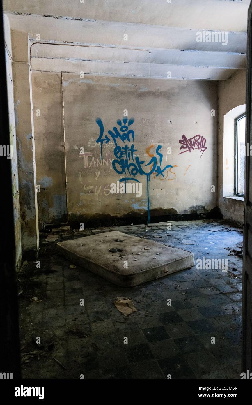 Scary looking ruined room with a dirty mattress Stock Photo Alamy
