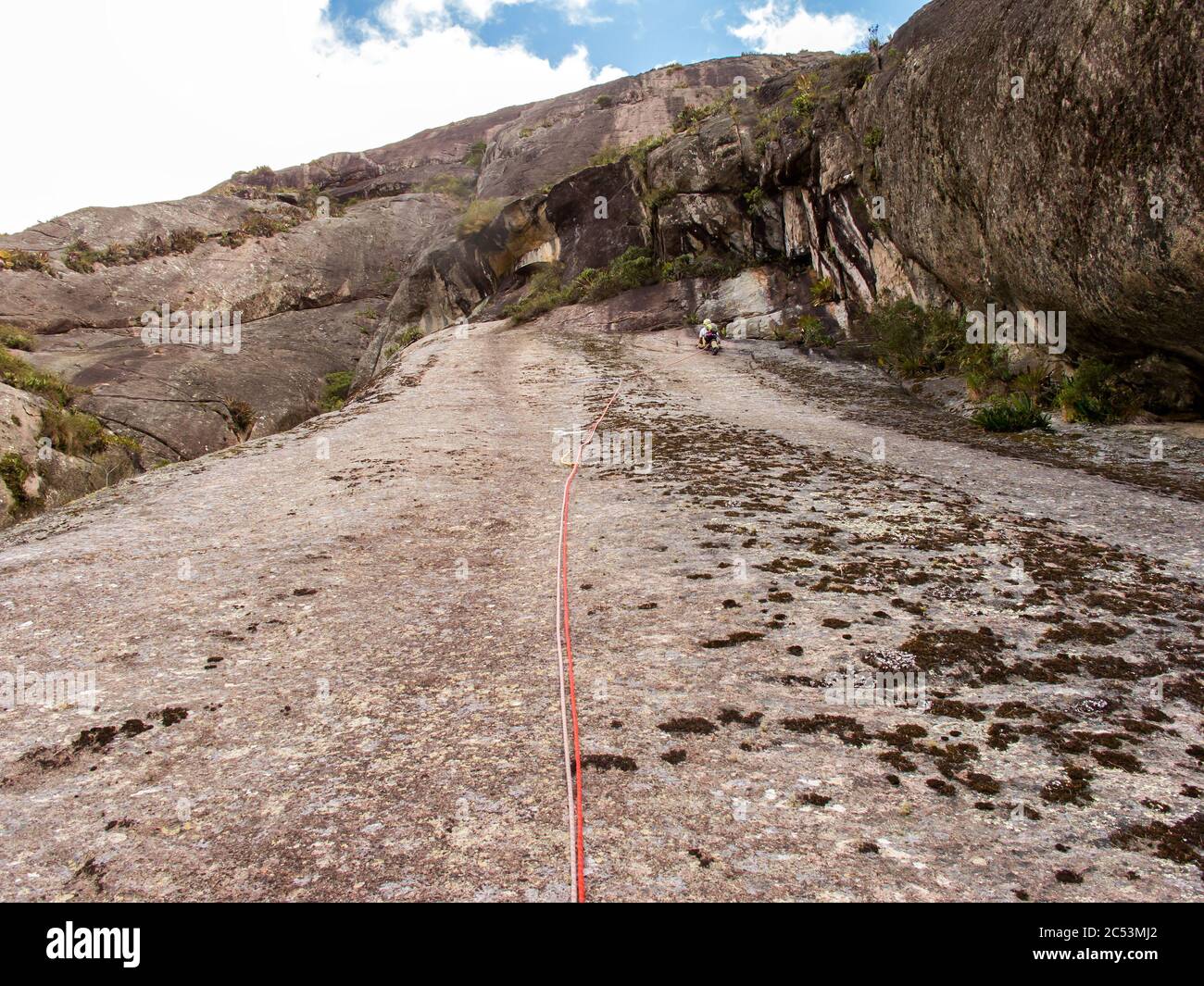 Rock climber climbing a sloping rock wall in Brazil Stock Photo Alamy