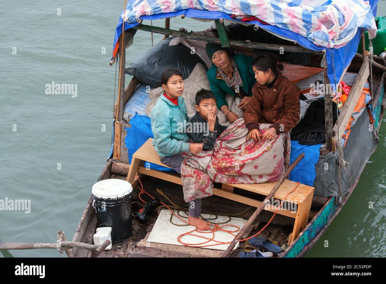 poor Vietnamese family members living in a house boat, poverty vietnam,halong bay,vietnames family,poor people,asia poor people,halong bay vietnam Stock Photo
