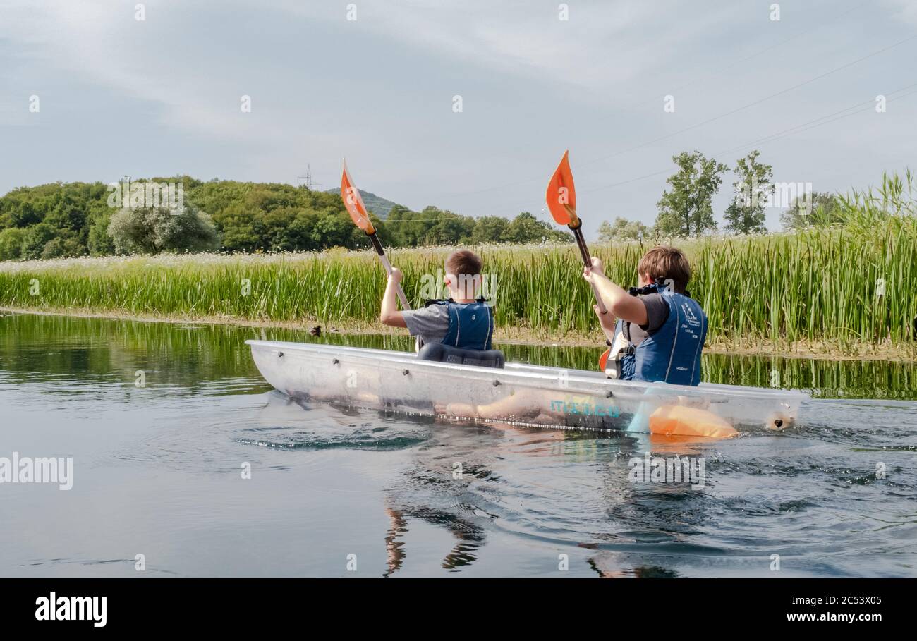 Young people enjoying a kayaking experience on the calm clear waters of the river Gacka, Otocac, Lika, Croatia Stock Photo