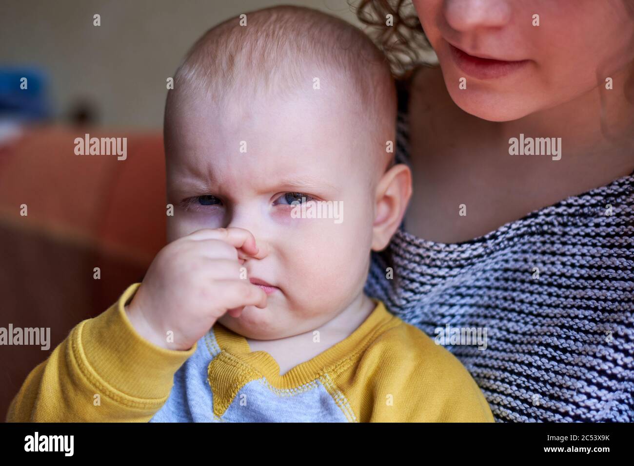 Little funny cute boy with finger in nose Stock Photo