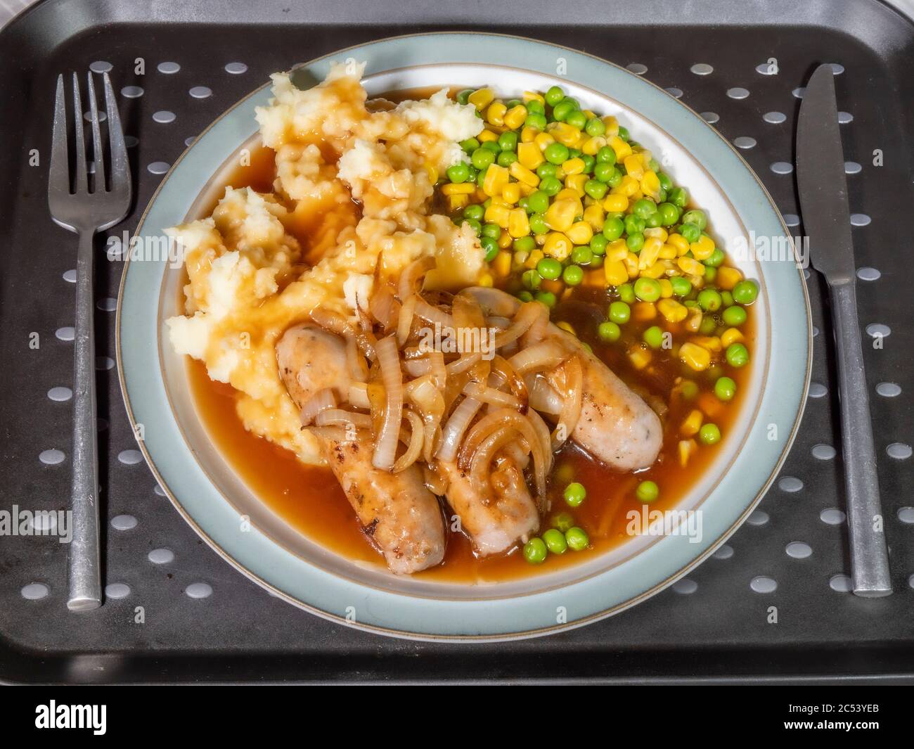 Overhead shot of dinner on a tray, with a knife and fork next to the