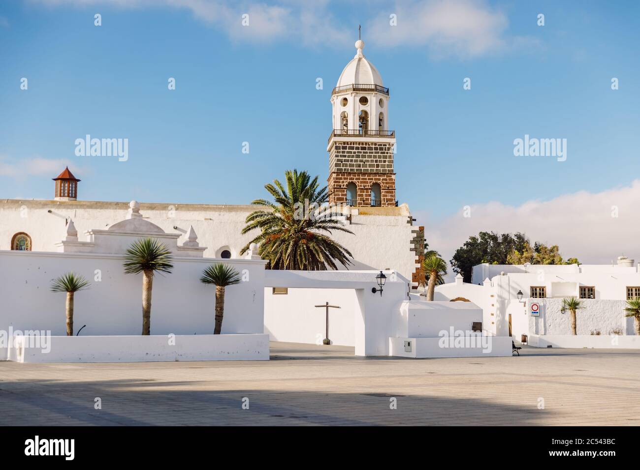 Lanzarote, Spain - April 04, 2020. The old architecture of city of Teguise. Church Iglesia de Nuestra Senora de Guadalupe and palms Stock Photo