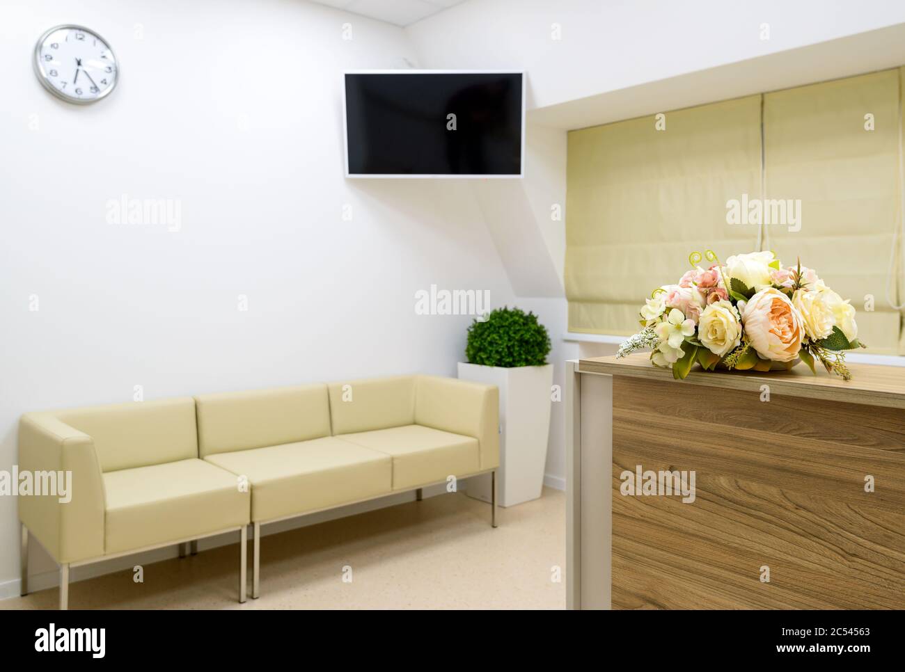 Reception with flowers on the blurred clinic or office background Stock Photo