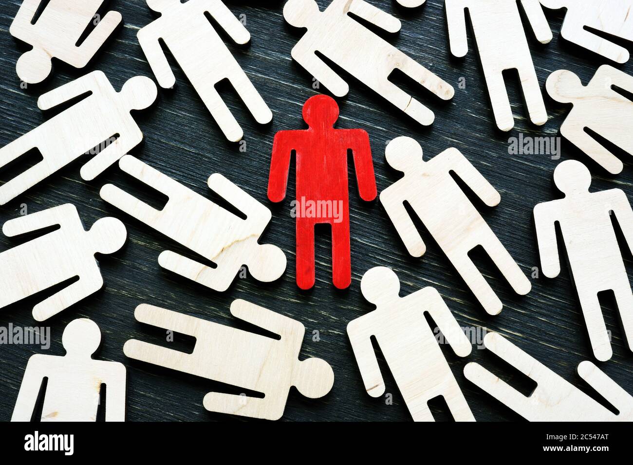 Talent acquisition concept. Red figure stand out from the crowd. Stock Photo